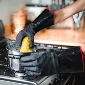 Chef grilling with fire-resistant gloves